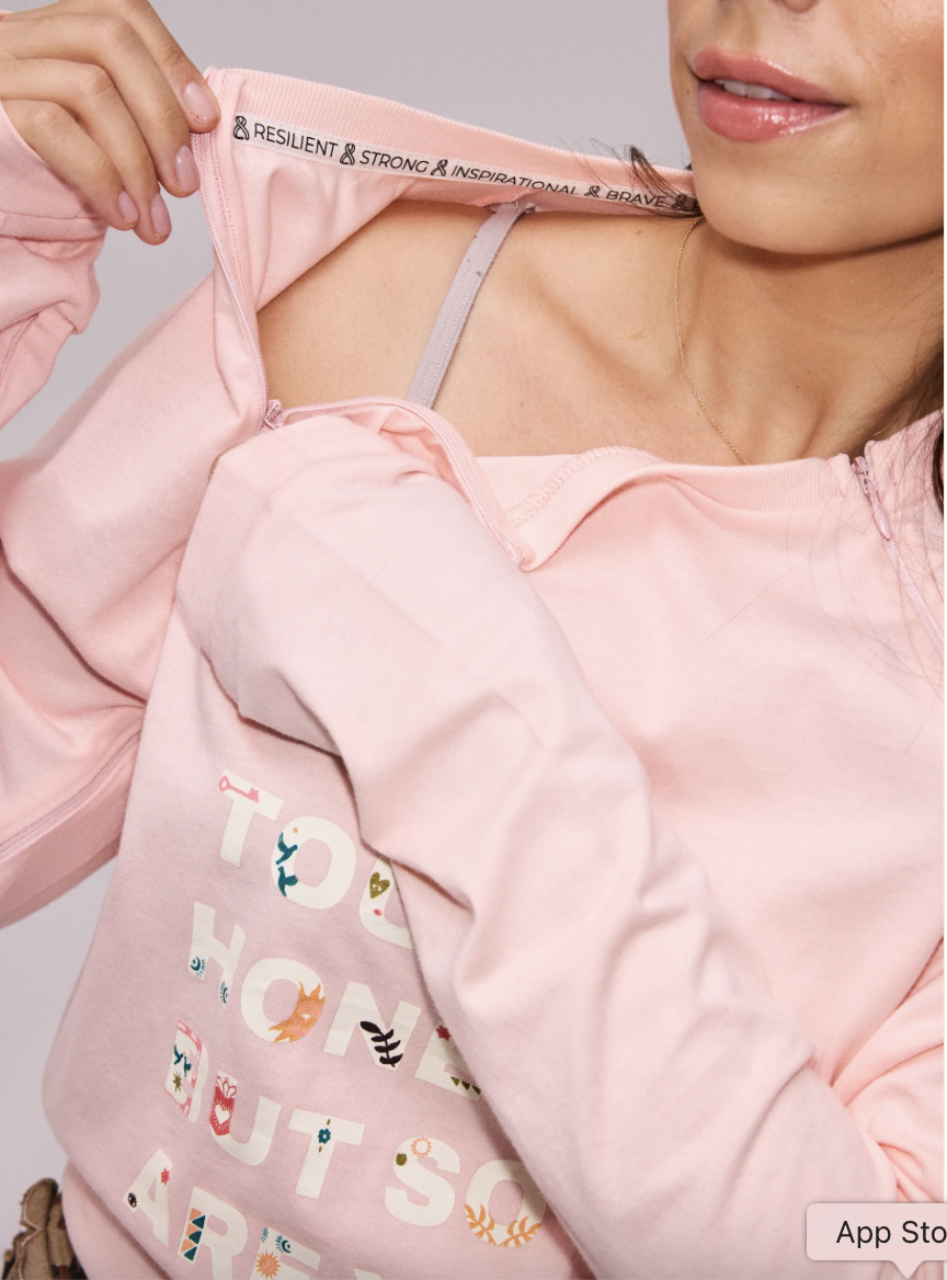The "Life Is Tough" Long Sleeve T-shirt in pale pink with arm and chest access with zip openings..